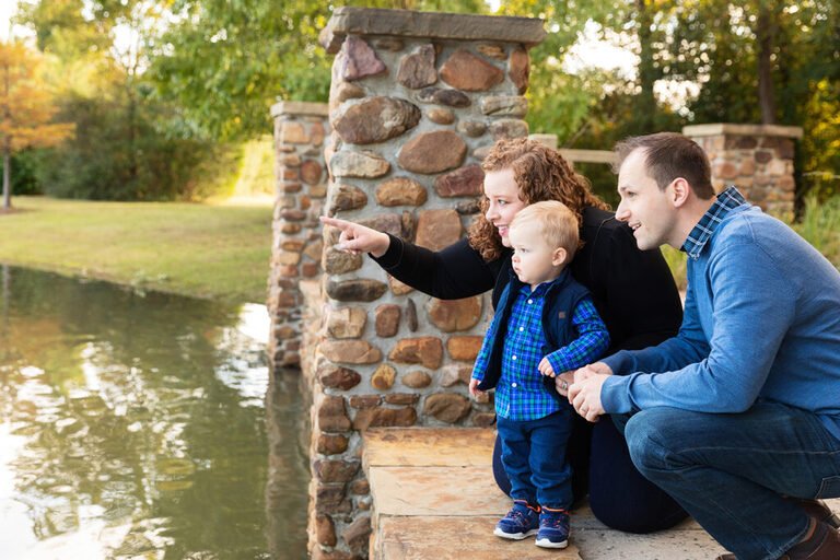 Family of three in a Woodlands TX park during their fall session with Kara Powell Photography.