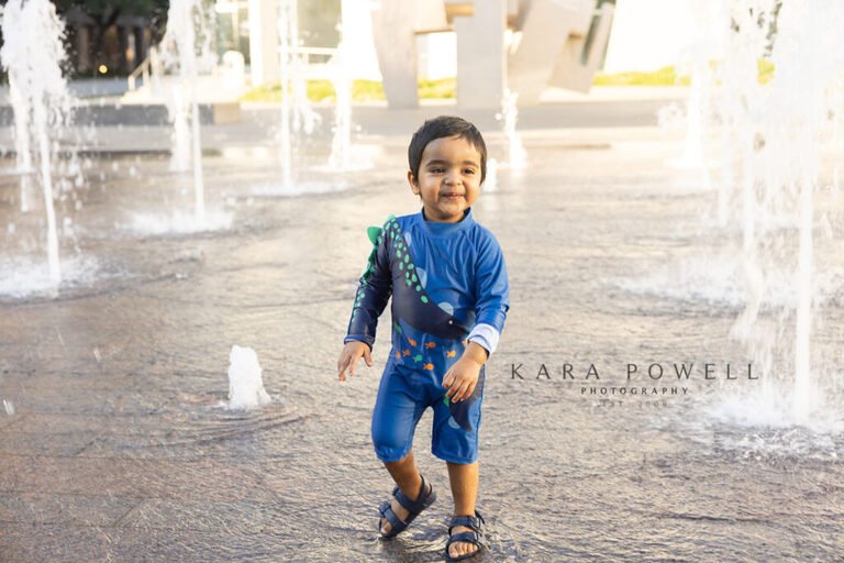 Mr. K running at a splash pad during his 18 month session. Kara Powell Photography