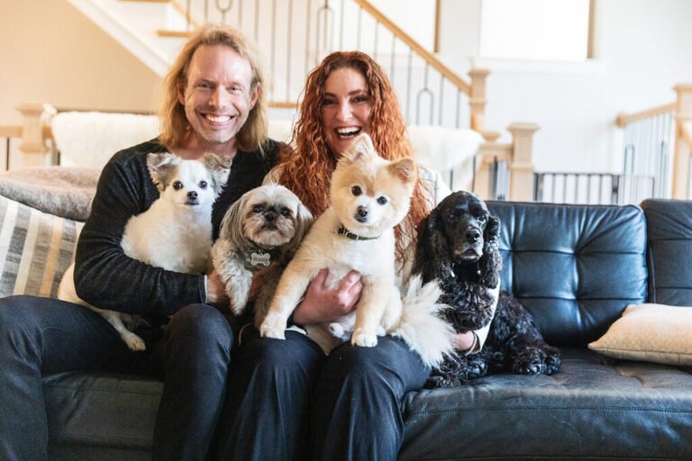 Couple with their three dogs during their at-home session in the Woodlands TX with Kara Powell Photography.