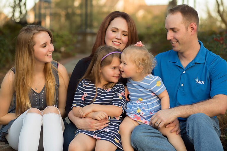 Woodlands TX family cuddling in the park. Taken by Kara Powell Photography.