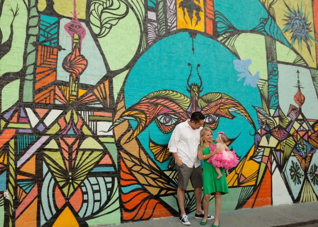 Family of three in front of graffiti wall in Houston TX