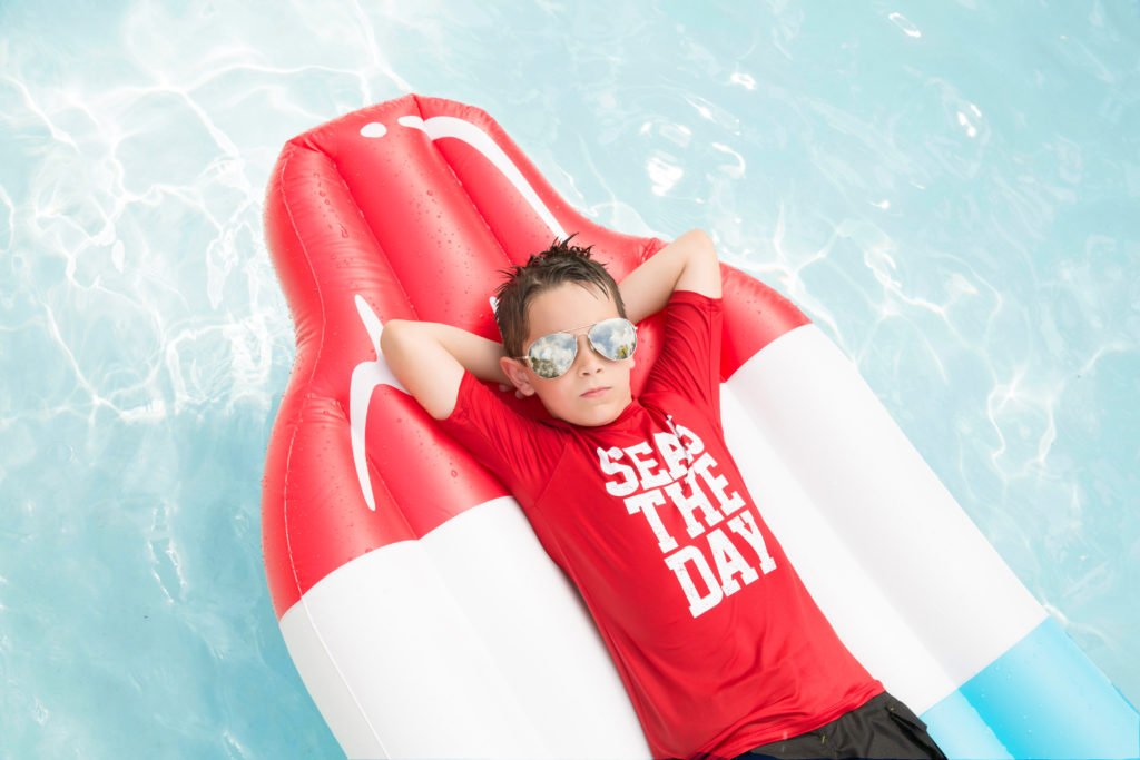 The Woodlands TX eight year old laying on a float in Carl Barton Park