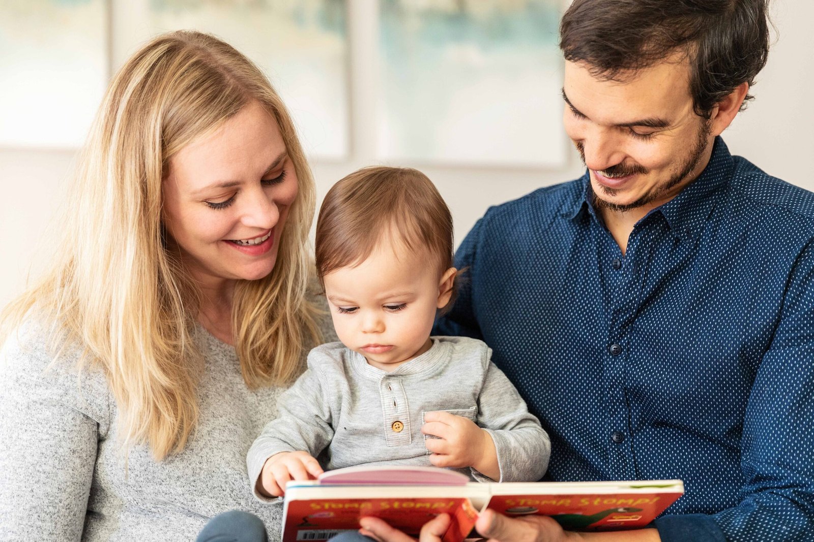 Couple with their one year old son reading in Houston TX