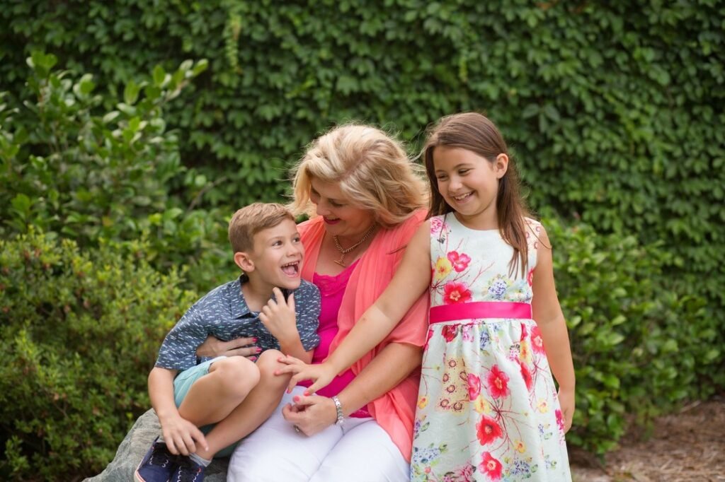 Mother with two children in front of ivy wall in the Woodlands TX