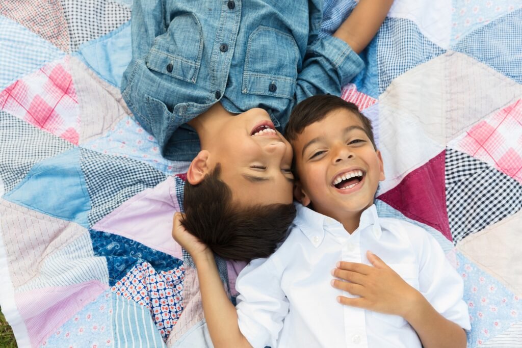 Brothers cuddling on a quilt in Tomball TX