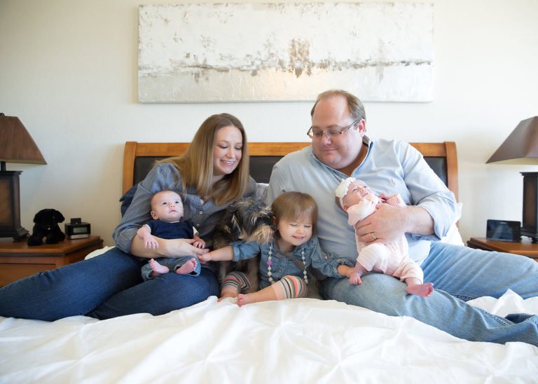 Lifestyle Photos - Family of 5 cuddling on a bed with their dog