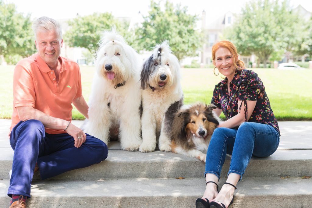 Woodlands Dog Photographer -  Couple poses with their 3 dogs on steps