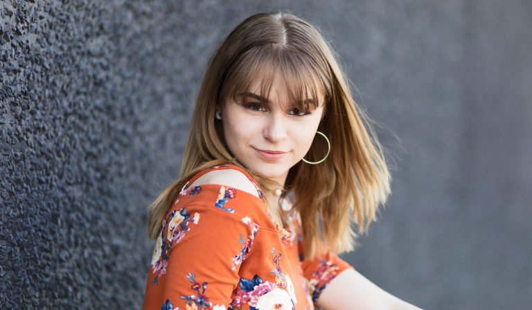 The Woodlands Senior Photographer with a senior on a black background