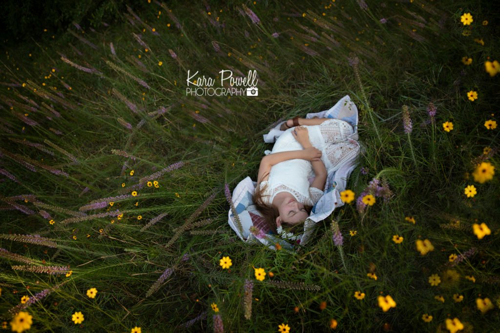 Conroe Child Photographer - Girl lays in a field of flowers