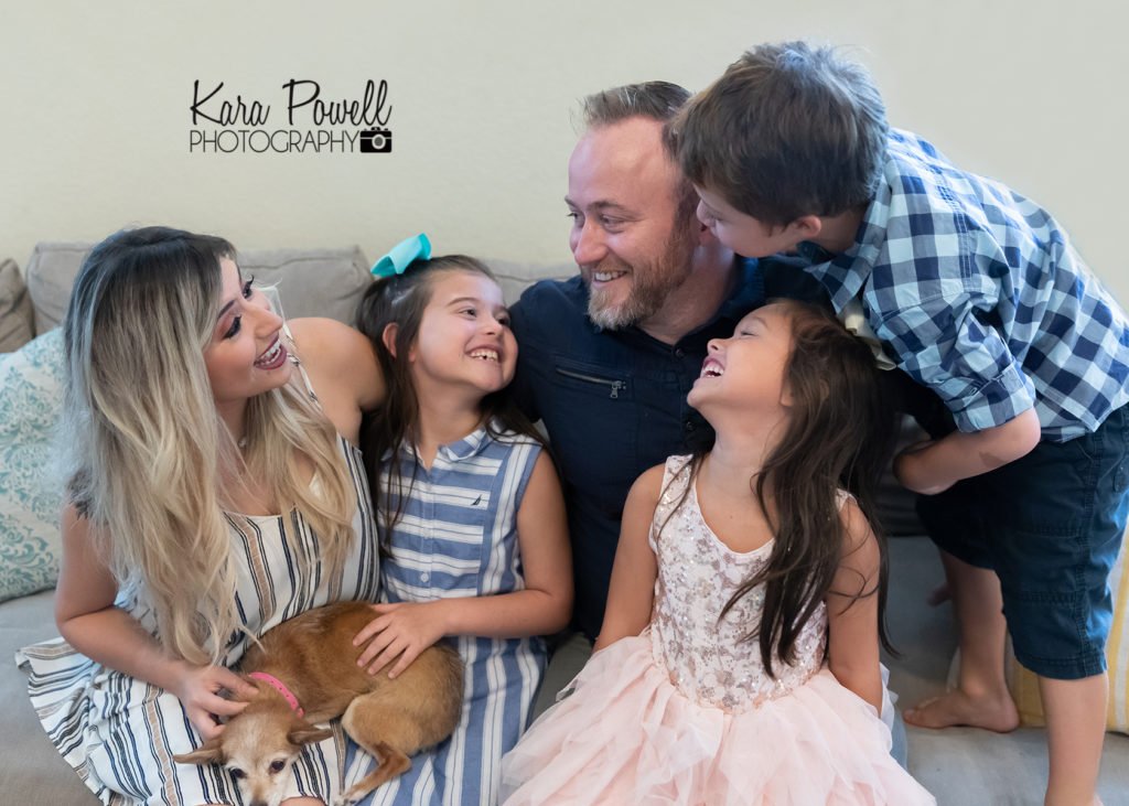 Katy TX lifestyle photographer - Family of 5 sitting on the couch with their chihuahua.