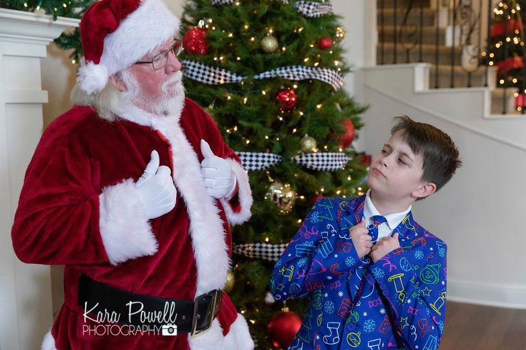 Woodlands TX ten year old spending quiet time with Santa at Kara Powell Photography's studio