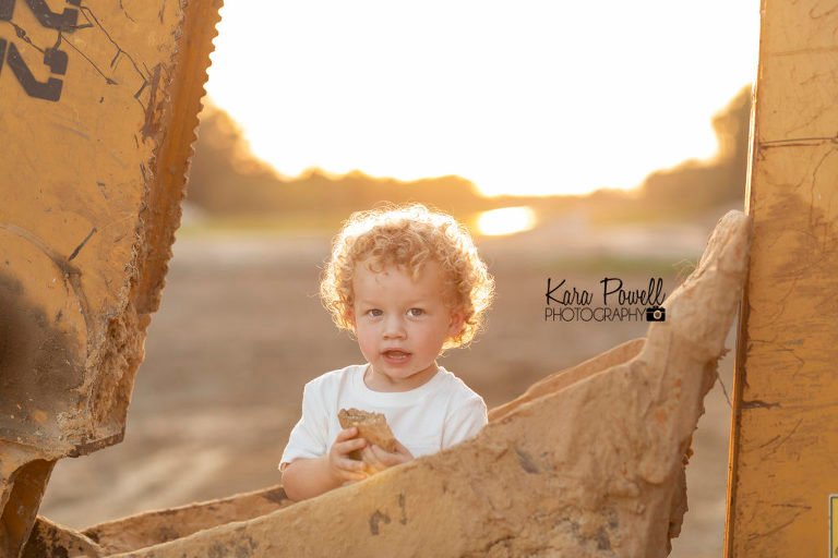 Woodlands Children Photographer - Boy sits in excavator bucket