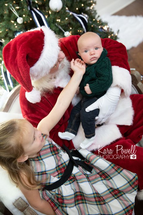 Woodlands TX siblings spend quiet time with Santa at Kara Powell Photography's studio