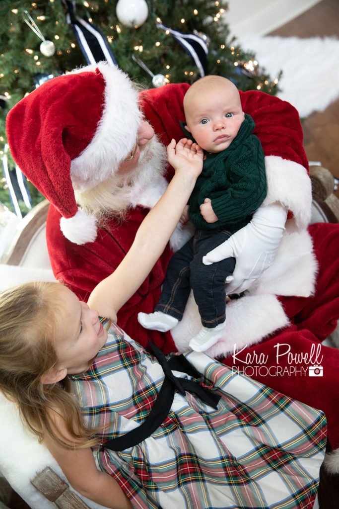 Woodlands TX siblings spend quiet time with Santa at Kara Powell Photography's Santa mini sessions
