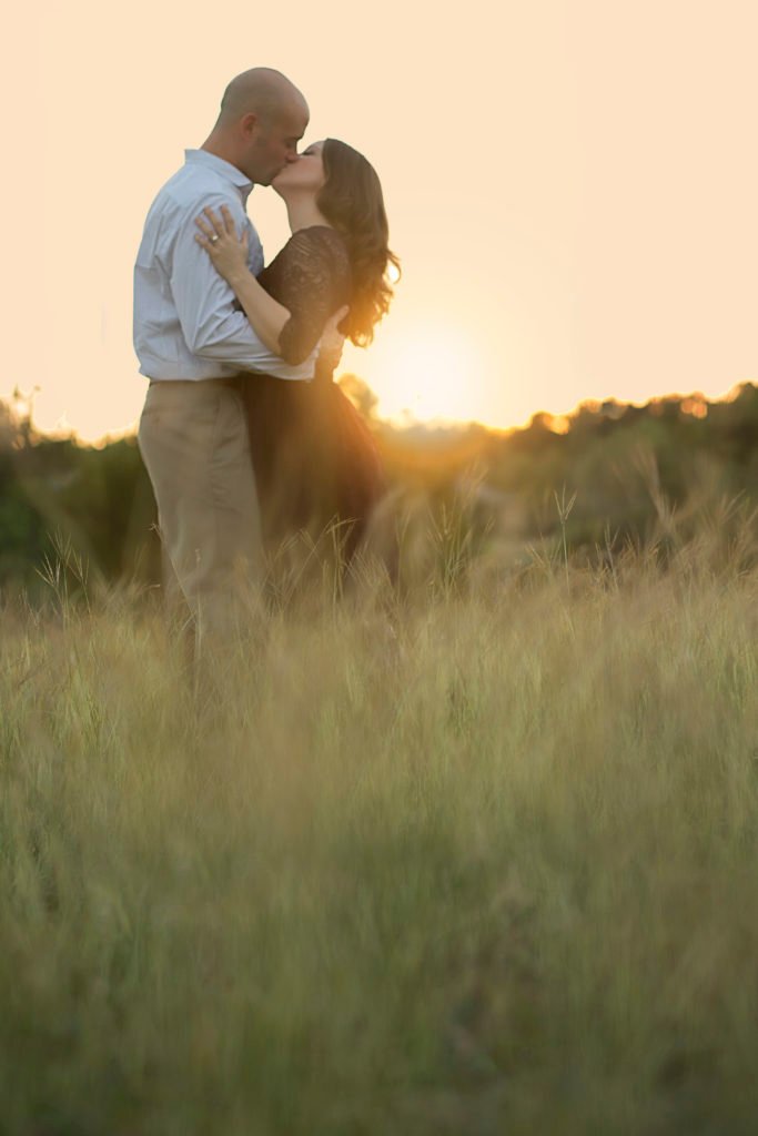 Katy TX engaged couple kissing in a field in Montgomery