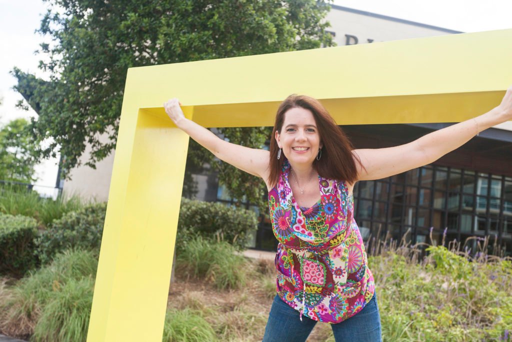 A photographer is pictured having fun in a sculpture at Hughes Landing in The Woodlands. When you love what you do, you never have to work a day in your life.
