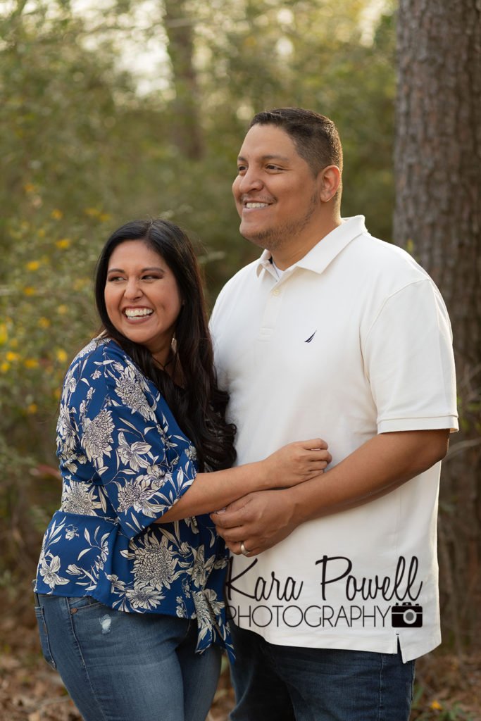 Photo of two parents smiling at their children who are out of the frame of the photo. They were the parent spotlight.