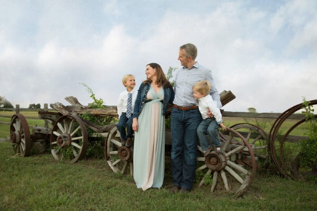 Fall family of four portrait on historic wagon in Montgomery TX