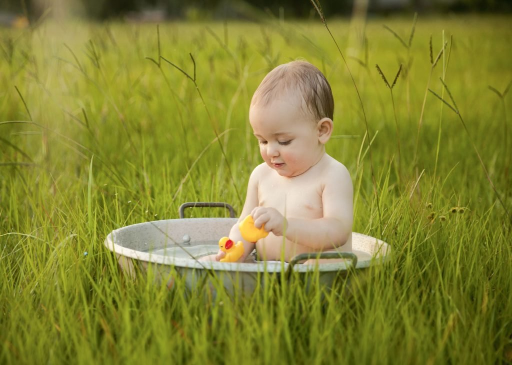 Child in bath in a field