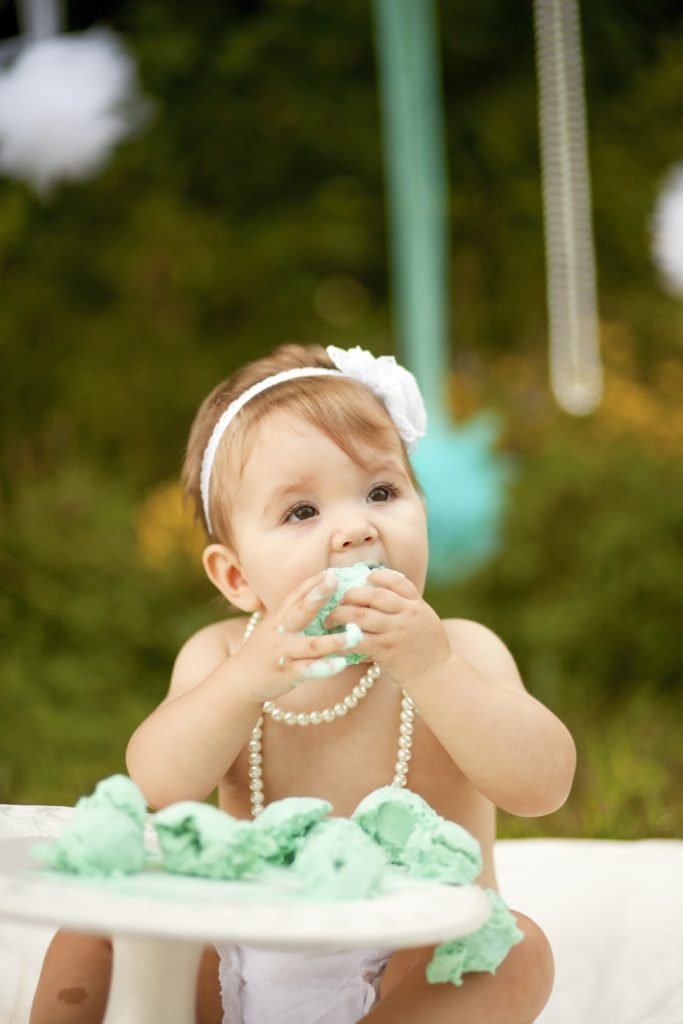 Woodlands TX girl enjoying ice cream for her one year cake smash. Ice cream smash photos