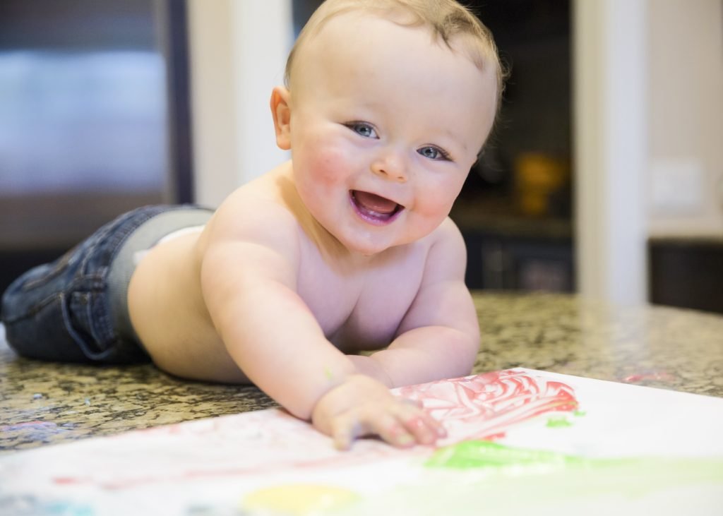 little boy painting canvas