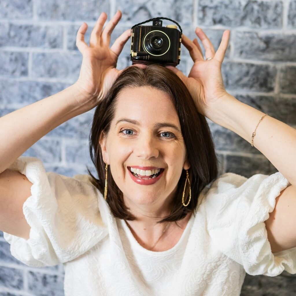 Kara Powell poses with a camera over her head to celebrate "happy Birthday to me"