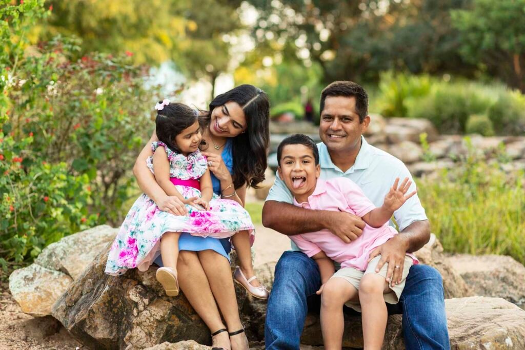 Family of four by waterfall in Katy TX