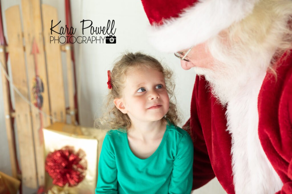 A little girl meets Santa at Kara Powell Photography's Santa Photo Sessions