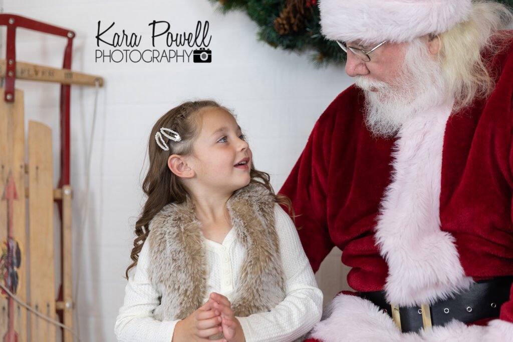 A little girl has a conversation with Santa