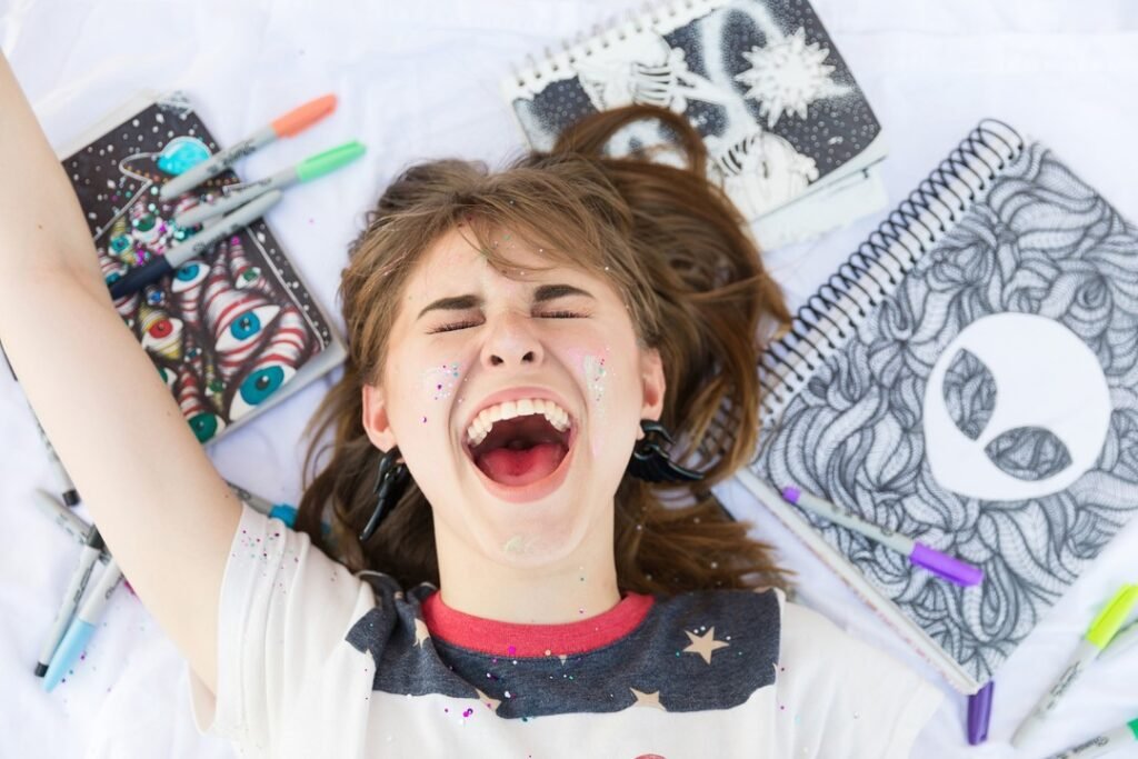 High School senior surrounded by her artwork photographed by a creative photographer