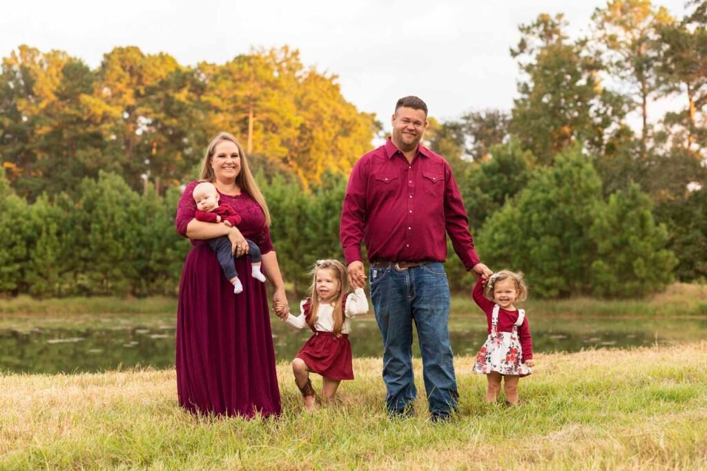 Parents with their three children in front of a pond. Their daughter is in the Tippy Toes Baby Plan