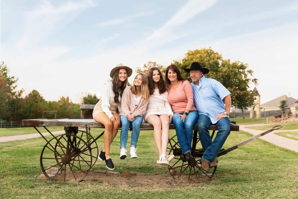 Family of five sitting on a vintage wagon in Montgomery TX