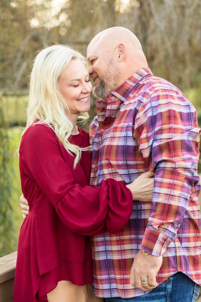 A husband and wife laugh together at Townhall TX fall family session