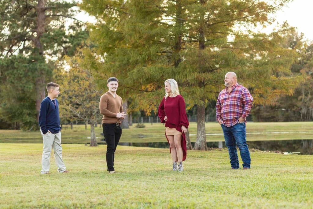Family of four photographed near a pond