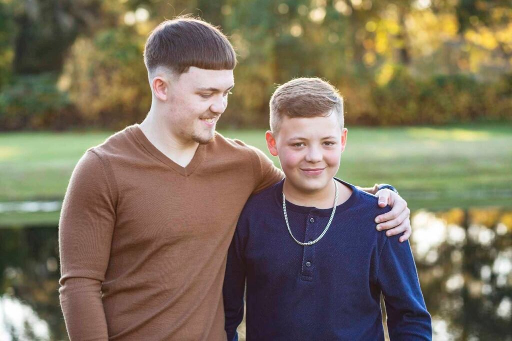 Two brothers pose together at their Townhall TX fall family session
