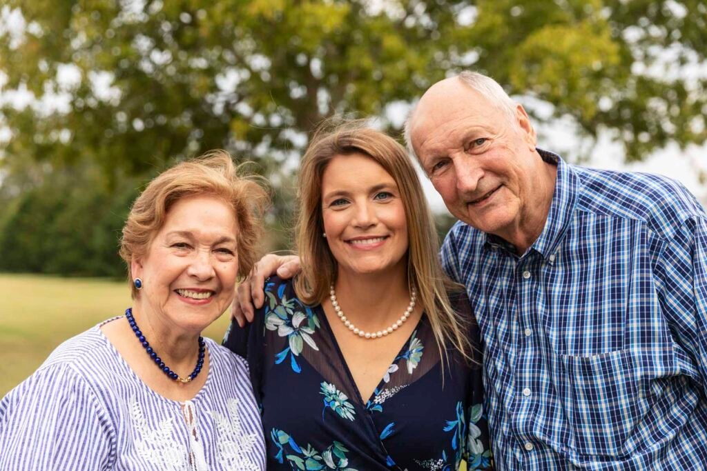 A daughter poses with her parents at a crazy fun family photo session