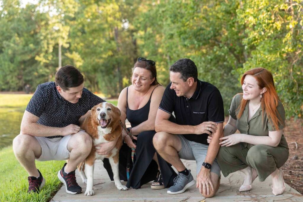 A family of four poses with their dog at Creekside park.