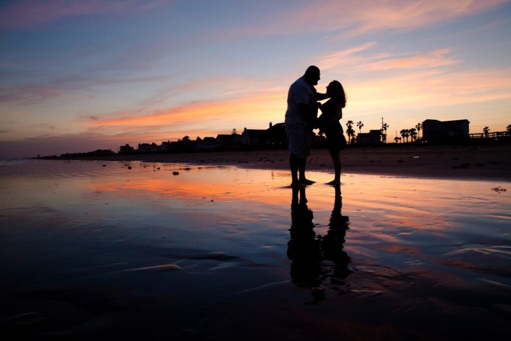 Expecting couple in sunset on Galveston island beach