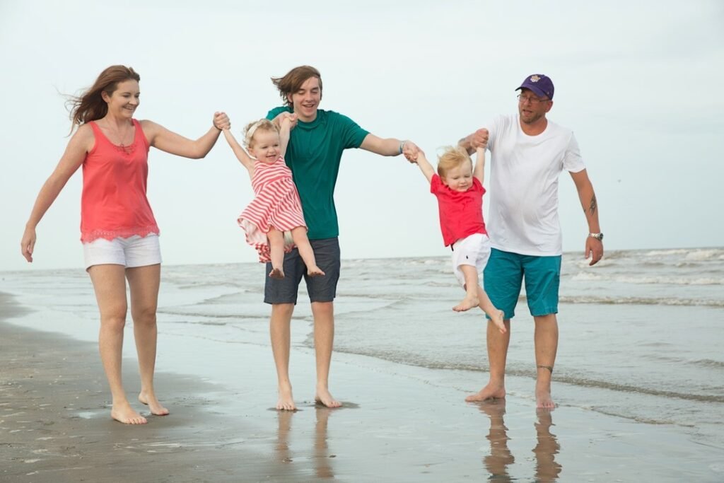 Family of five playing on the beach of Galveston island