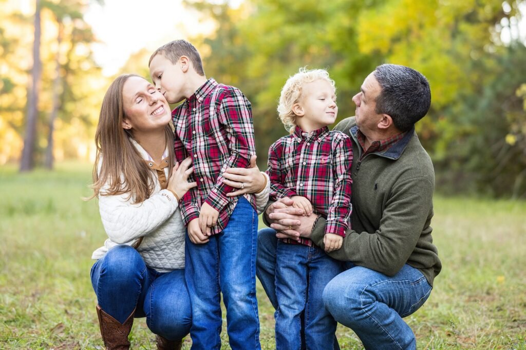 image of family in natural lighting standing for photoshoot in the woodlands, tx