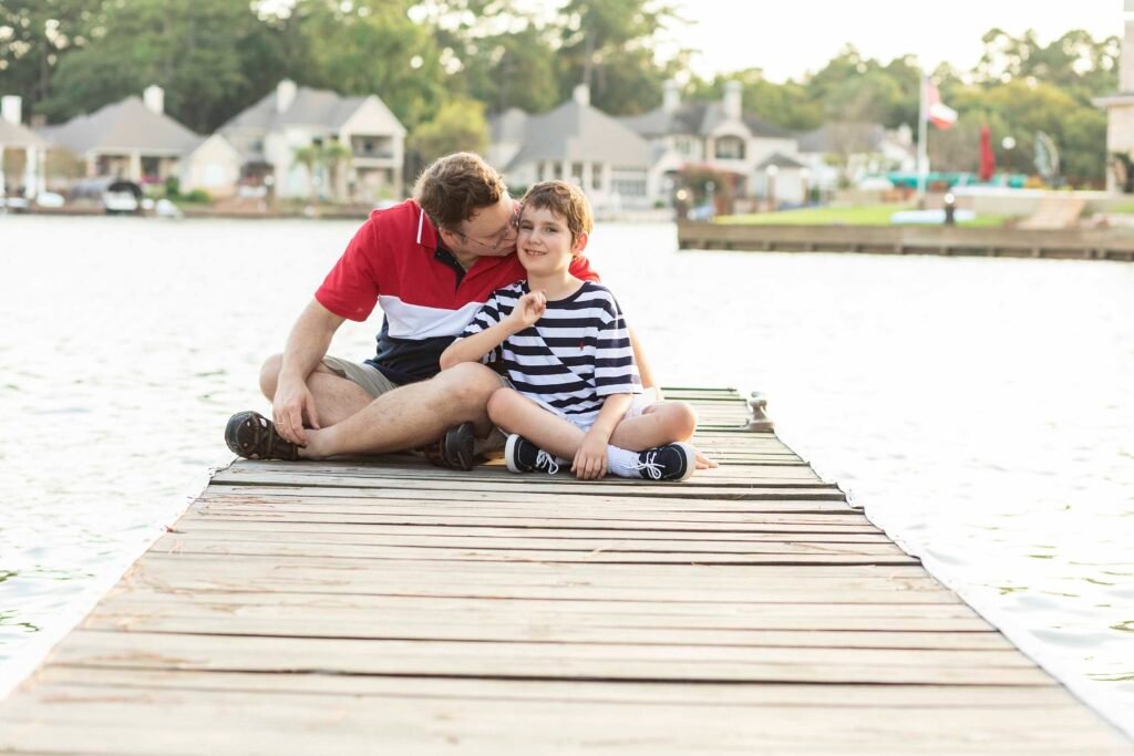 Father and son on dock on Lake Conroe