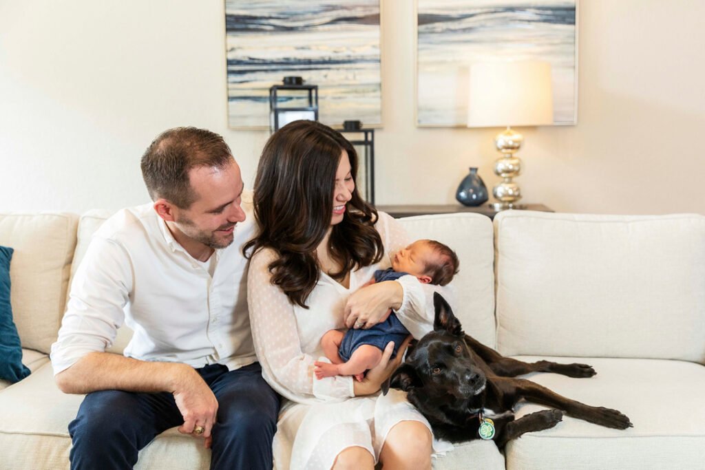 New parents with their fur baby and newborn baby boy during an at-home session in Katy TX