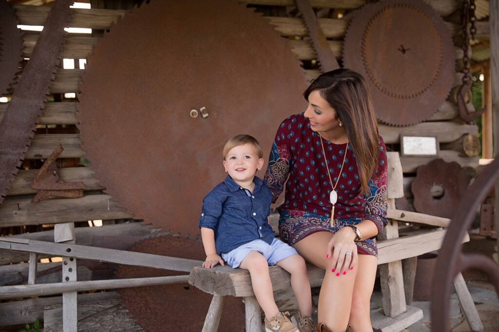 Mother with two year old by vintage saw blades in Montgomery TX