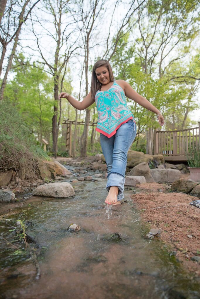 2019 Senior girl splashing water in a creek in Montgomery TX