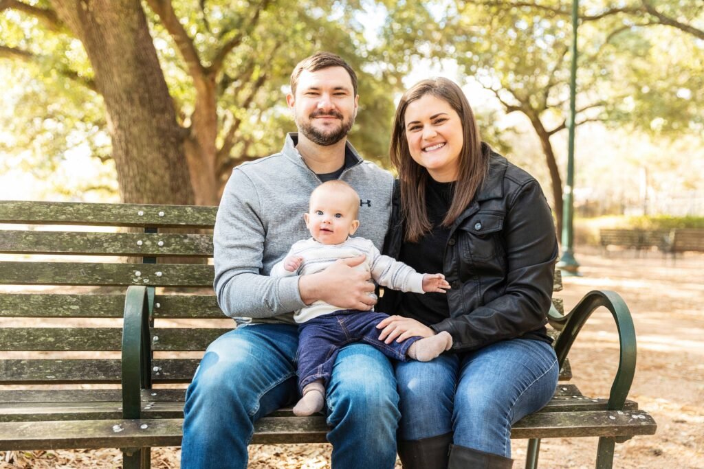 Parents with eight month old in Hermann Park in Houston TX
