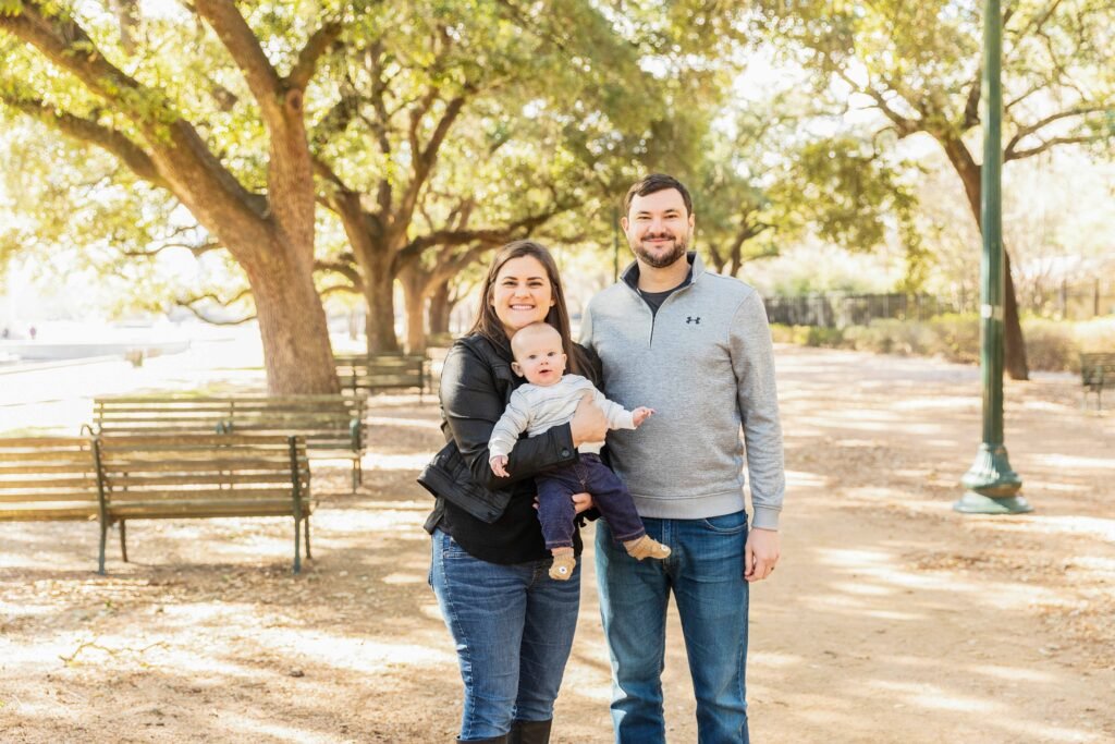 Parents with eight month old in Hermann Park in Houston TX