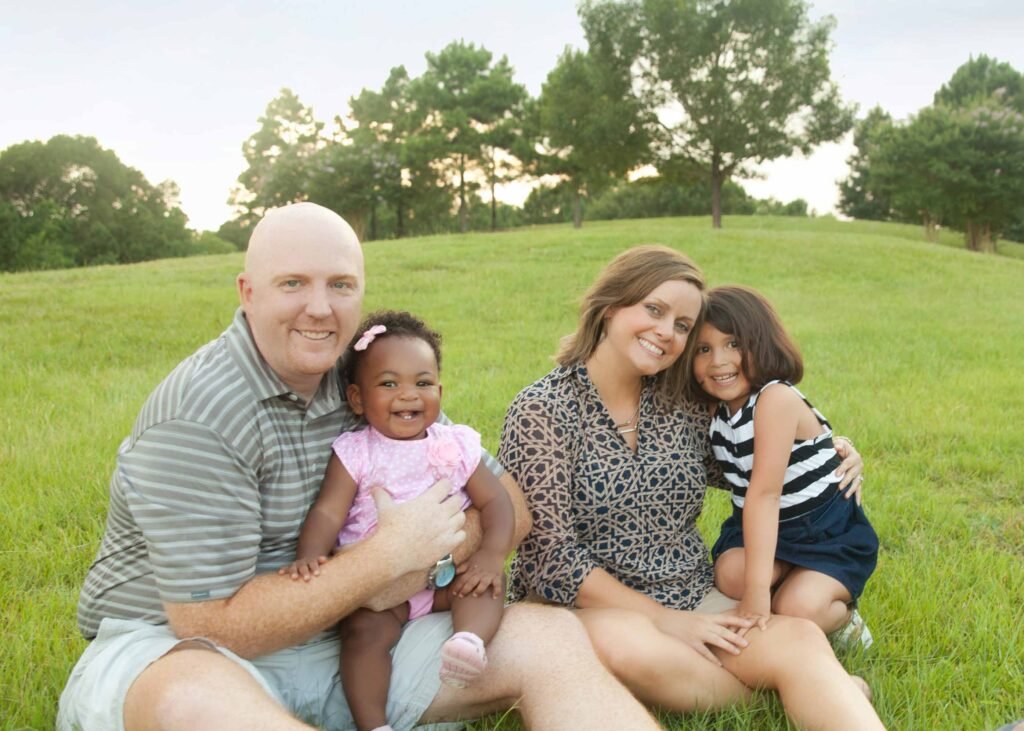 Family of four with their adopted daughters during spring session in the Woodlands TX