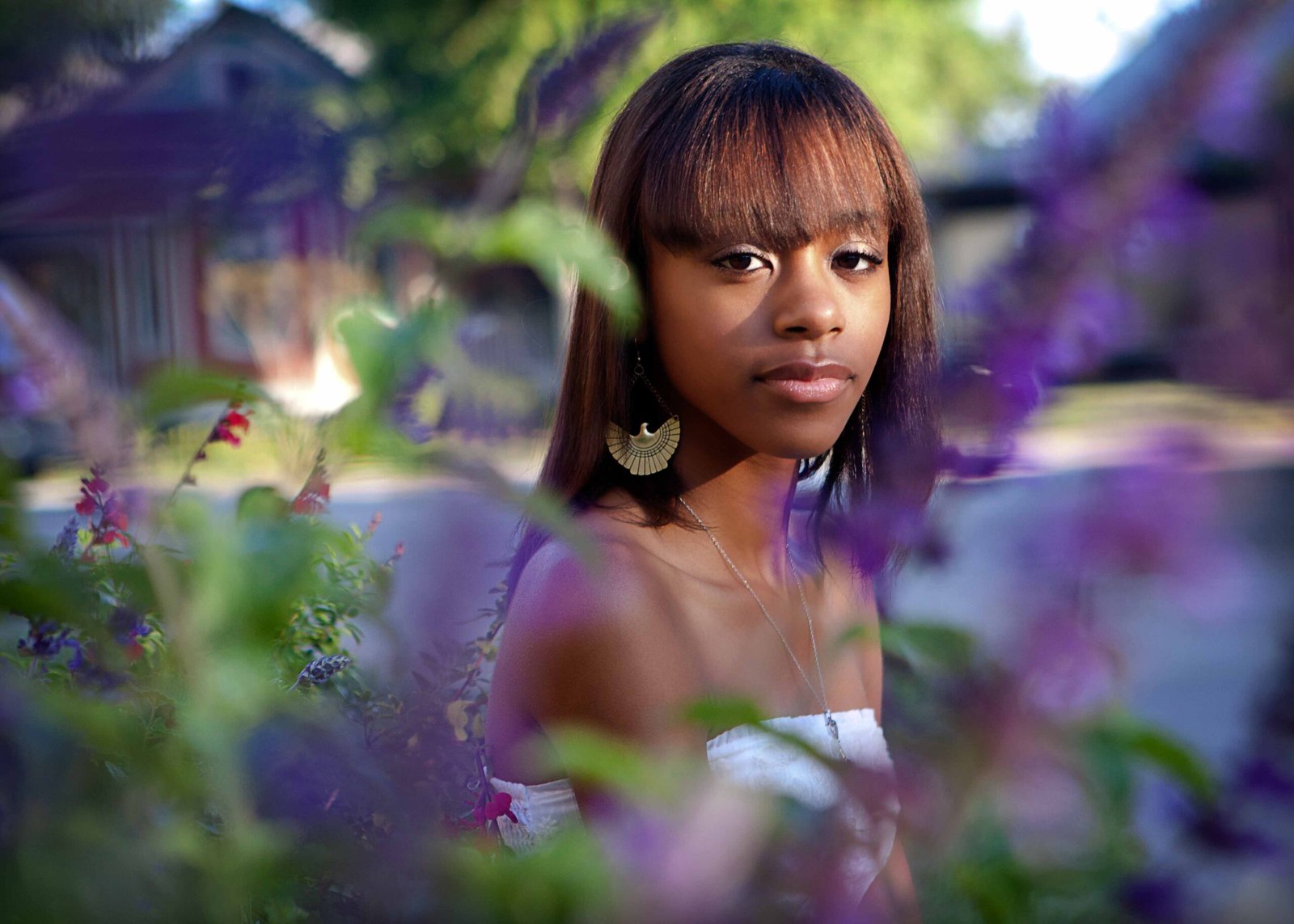 Senior in purple flowers in Old Town Spring