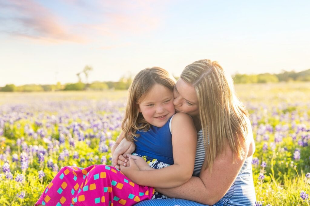 Mother and daughter in TX bluebonnets in Montgomery TX