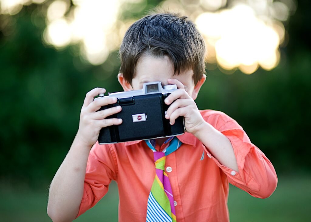 Four year old with vintage camera in Conroe TX